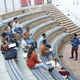 Male teacher lecturing at an outdoor classroom amphitheater
